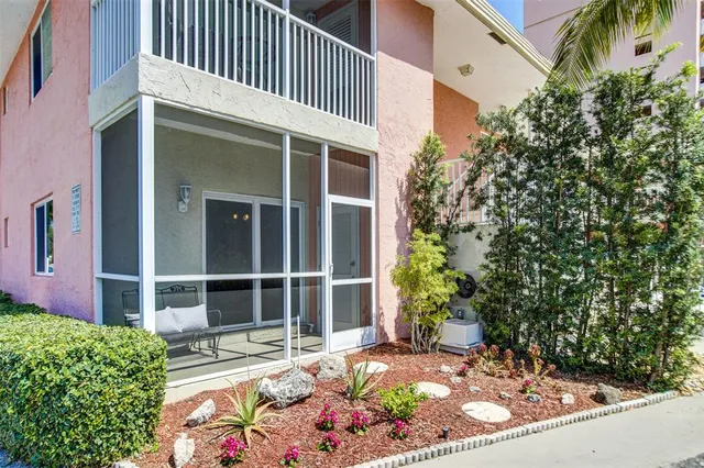 a view of a house with swimming pool and sitting area