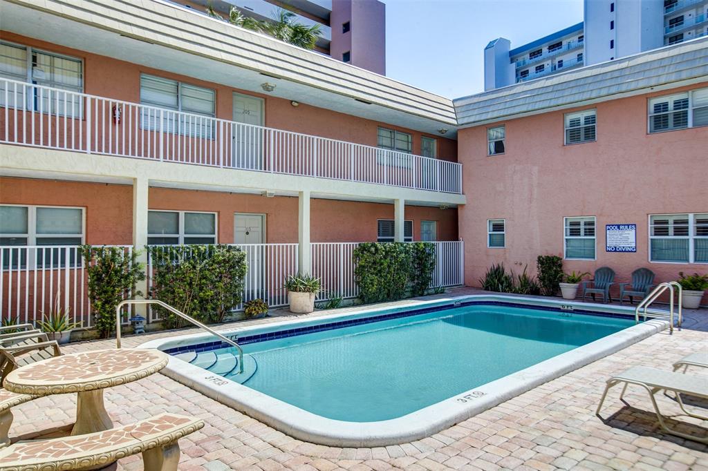 1450 North Riverside Drive, Unit 101 Pompano Beach, FL 33062 - Photo 39 of 52 a view of a house with swimming pool and sitting area