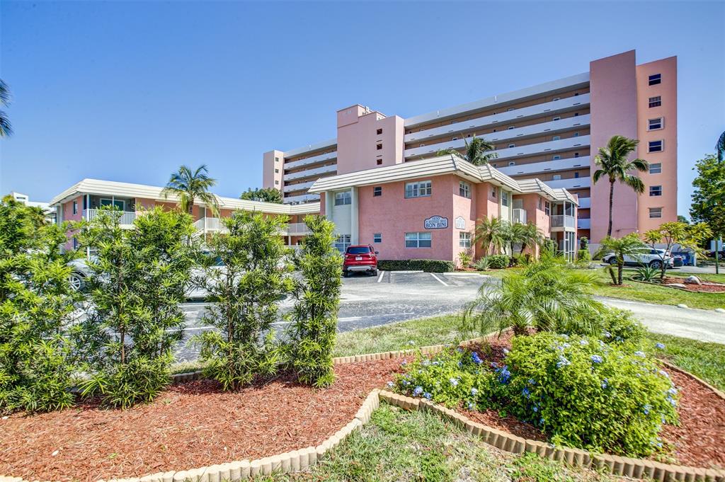 1450 North Riverside Drive, Unit 101 Pompano Beach, FL 33062 - Photo 52 of 52 a view of a house with a yard and potted plants