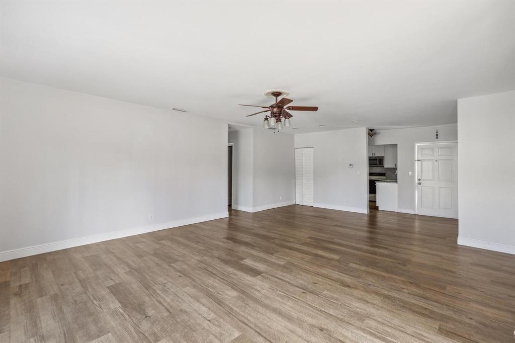 1450 North Riverside Drive, Unit 101 Pompano Beach, FL 33062 - Photo 9 of 52 a view of an empty room with wooden floor