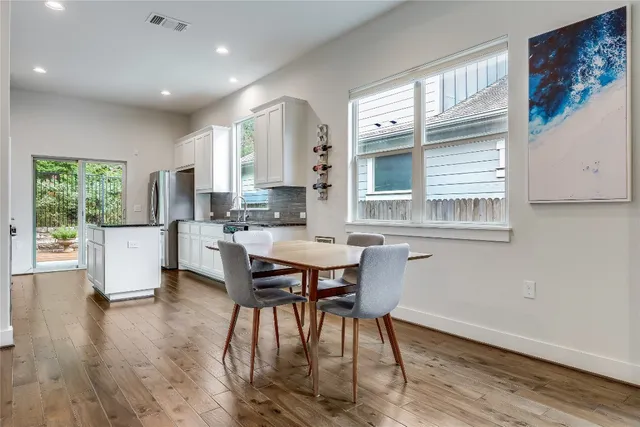 a view of kitchen with cabinets table and chairs