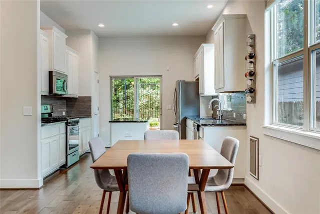 a dining room with furniture a window and a kitchen view