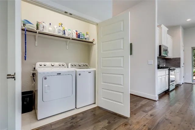 a utility room with cabinets washer and dryer