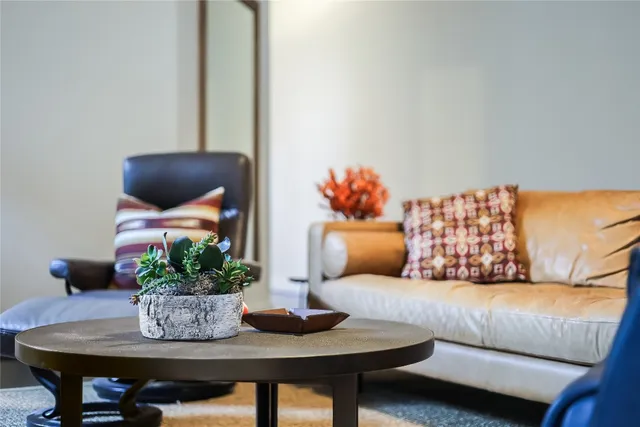 a living room with furniture and flowers