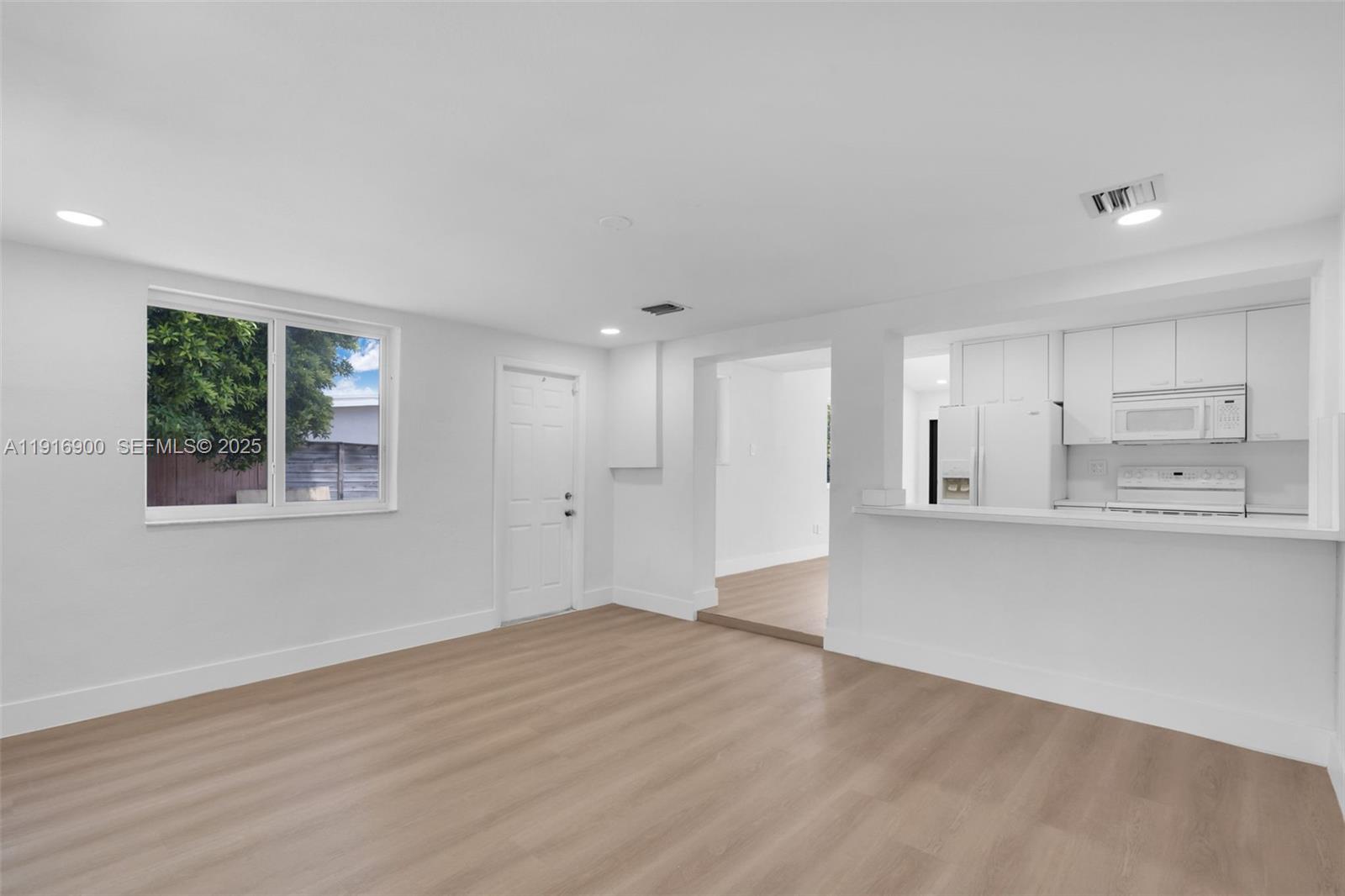 11030 Southwest 42nd Street Miami, FL 33165 - Photo 11 of 34 a view of kitchen with wooden floor and window