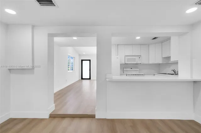 a kitchen with stainless steel appliances granite countertop a refrigerator sink and cabinets