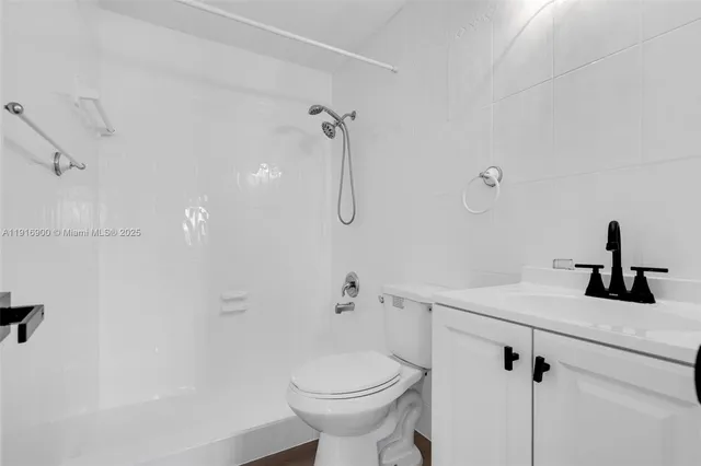 a bathroom with a sink toilet and shower