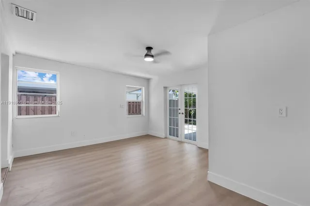 wooden floor in an empty room with a window