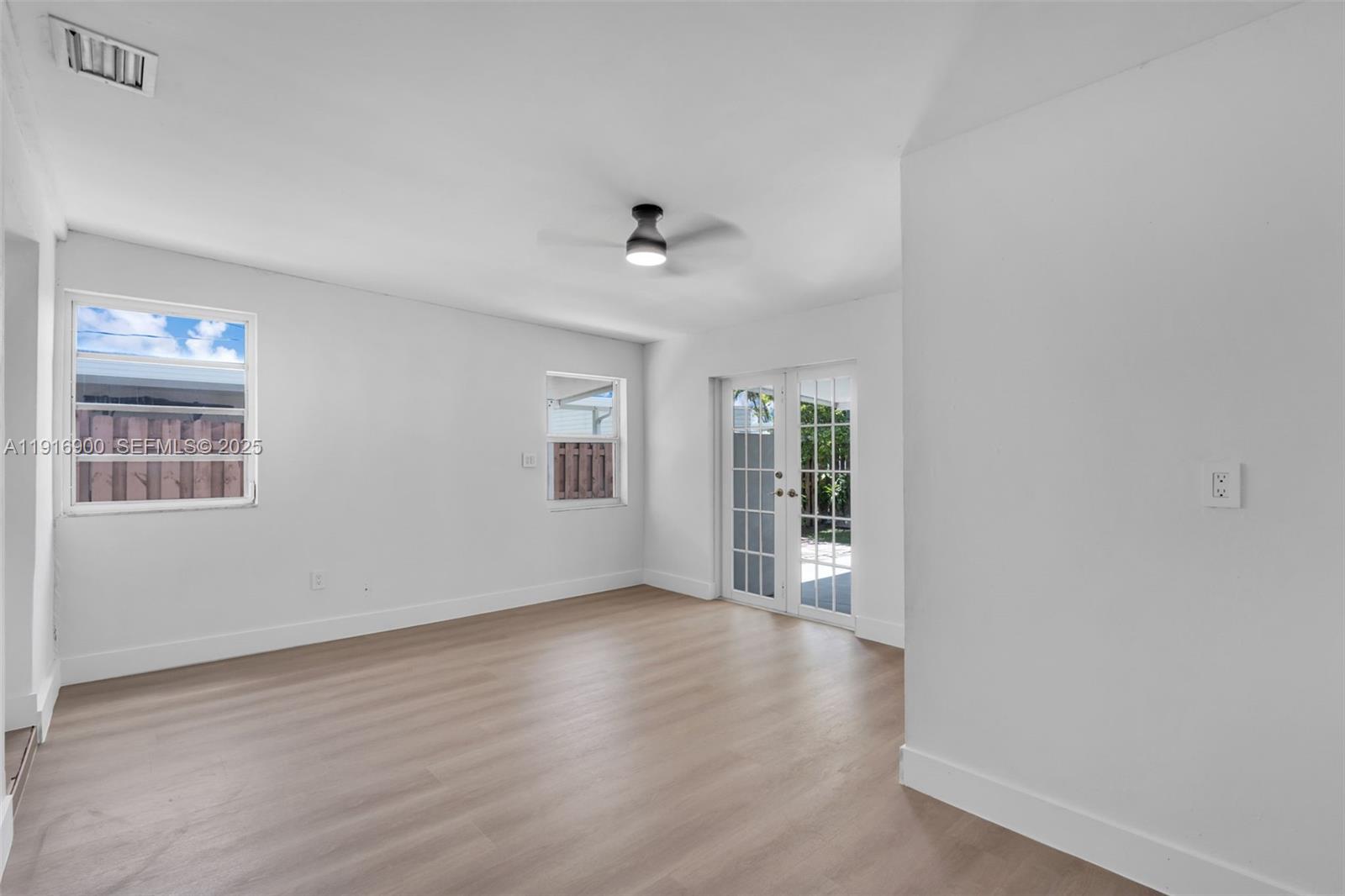 11030 Southwest 42nd Street Miami, FL 33165 - Photo 22 of 34 wooden floor in an empty room with a window