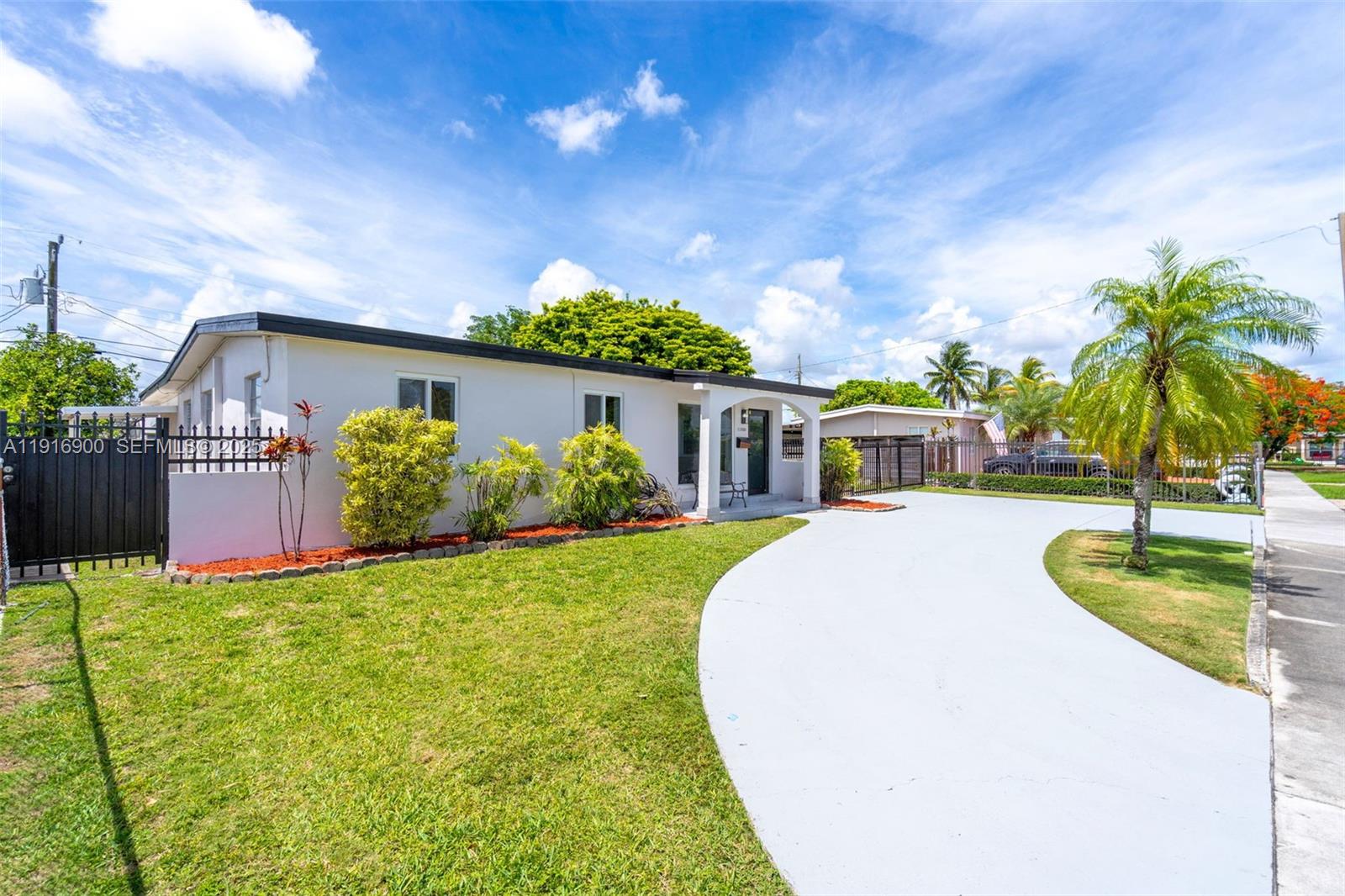 11030 Southwest 42nd Street Miami, FL 33165 - Photo 3 of 34 a front view of a house with garden