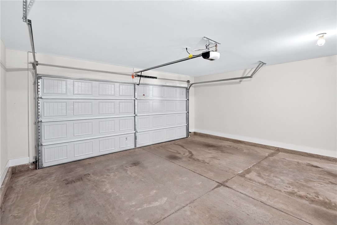 128 Whitman Way Easley, SC 29642 - Photo 25 of 34 This spacious two-car garage offers ample parking and additional storage solutions.