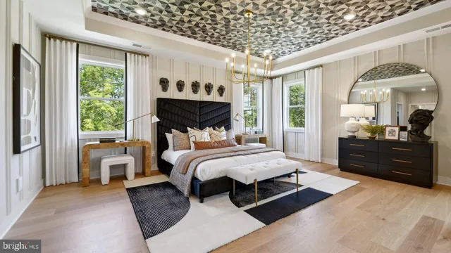 a bedroom with a large bed and a chandelier