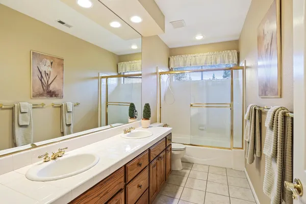 a bathroom with a double vanity sink a mirror and a shower