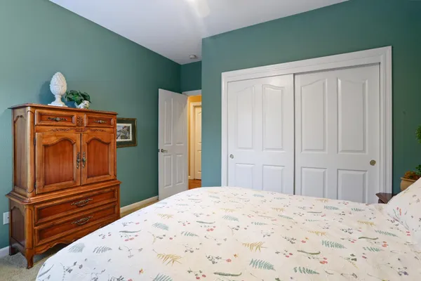 a bedroom with a bed and wooden cabinets