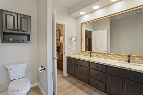a bathroom with a toilet sink and mirror