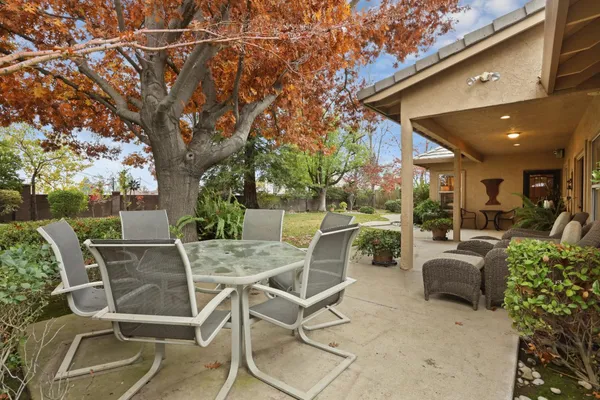 a view of a patio with table and chairs and potted plants
