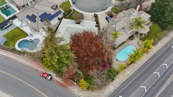 an aerial view of a residential houses with street