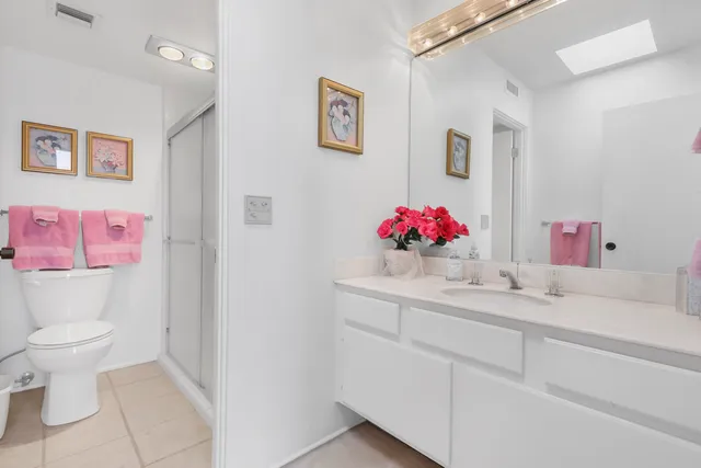 a bathroom with a sink mirror vanity and toilet