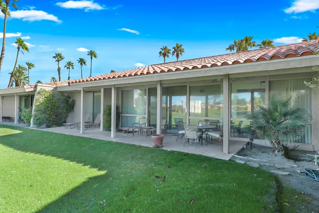 a view of a house with a backyard porch and sitting area