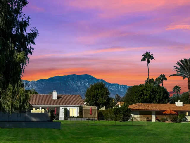 a view of a big house with a big yard