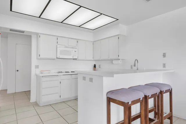 a kitchen with cabinets a sink and appliances