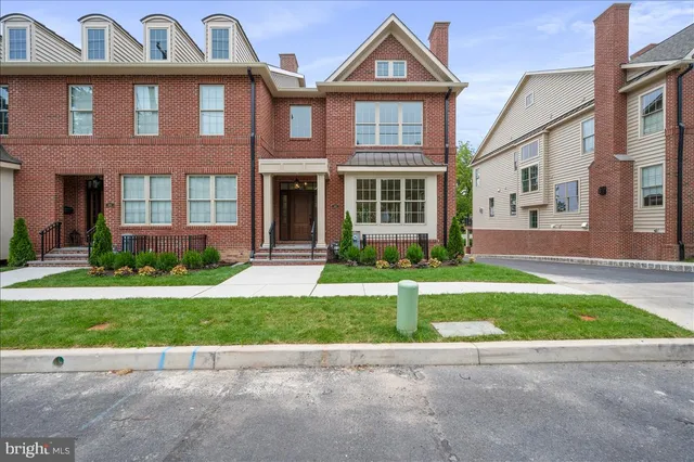 a view of a brick building next to a yard