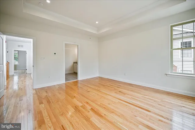 a big room with wooden floor and windows