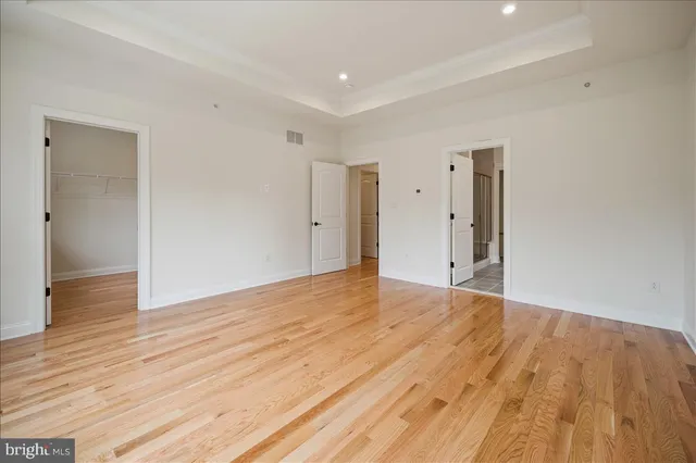 a view of an empty room and wooden floor