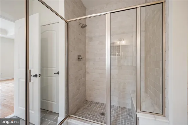 a bathroom with a glass shower door