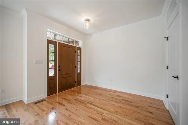 a view of empty room with wooden floor