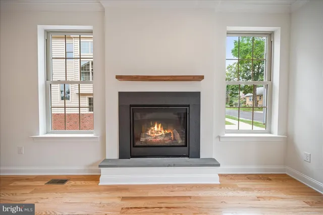 a living room with a fireplace windows and a fireplace