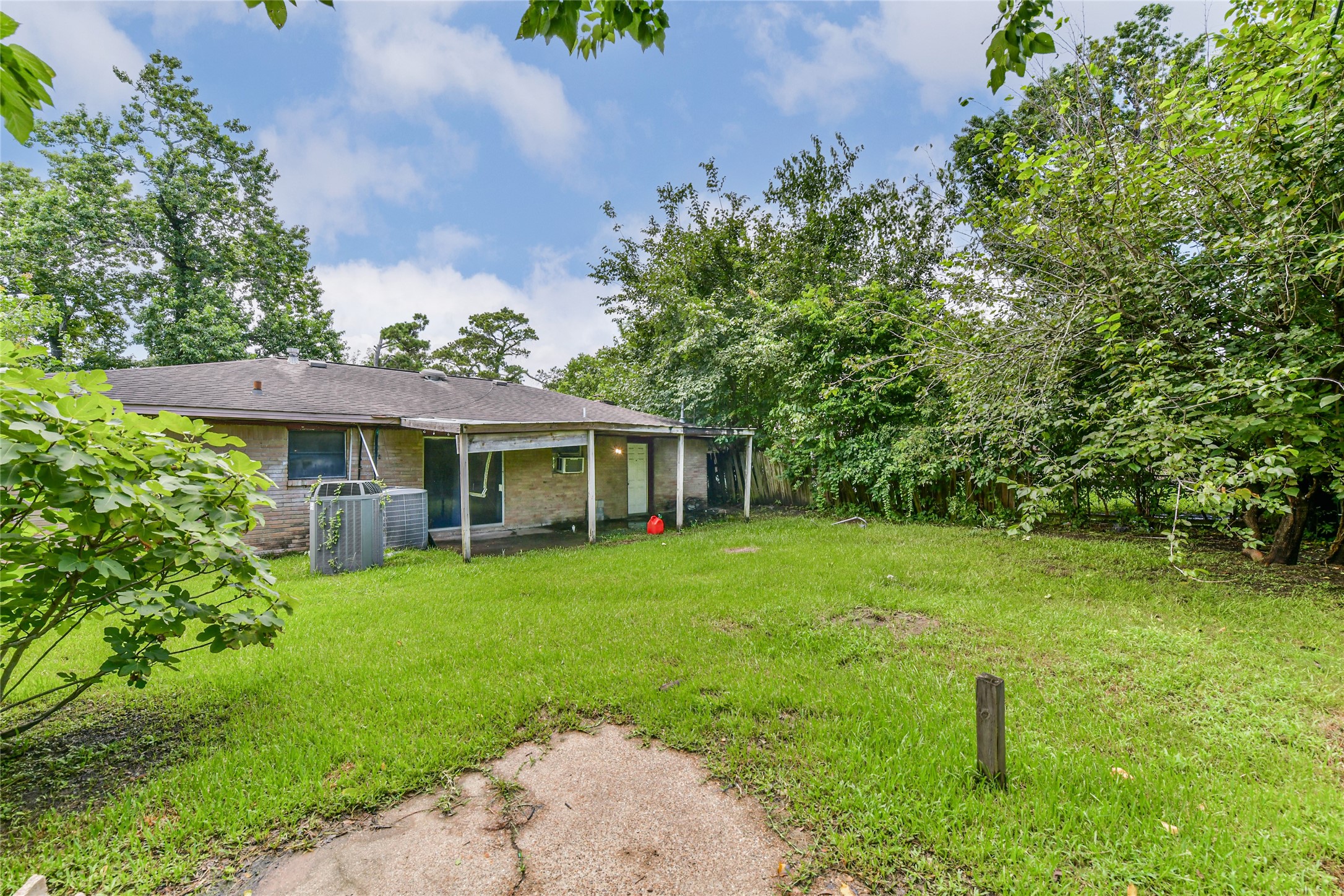 10438 Caxton Street Houston, TX 77016 - Photo 23 of 24 a front view of a house with a garden