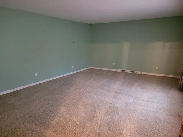 a view of a room with a window and a door