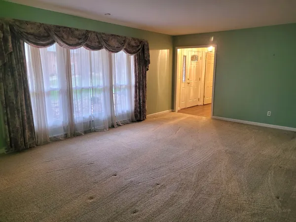 a view of a room with wooden floor and white walls
