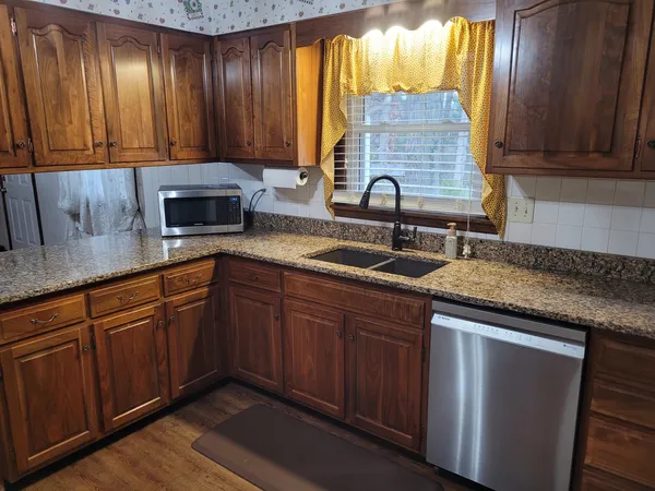 a kitchen with granite countertop a stove and a refrigerator