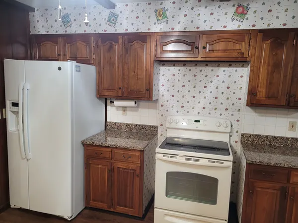 a view of empty room with wooden floor and stairs