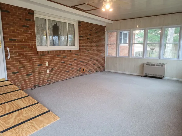 a view of wooden floor and brick walls