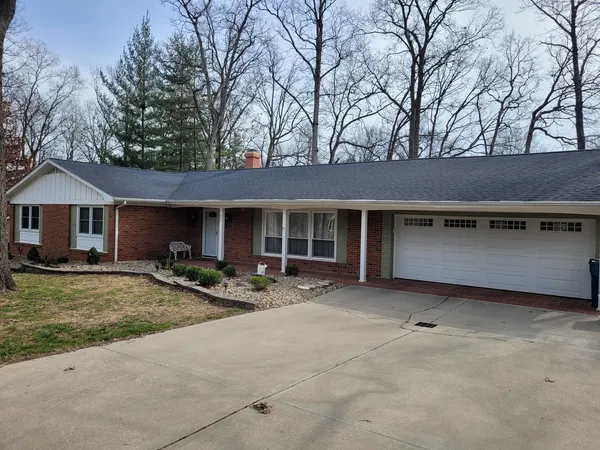 a front view of a house with patio furniture and a yard