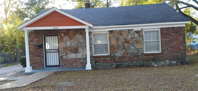 a front view of a house with glass windows and yard