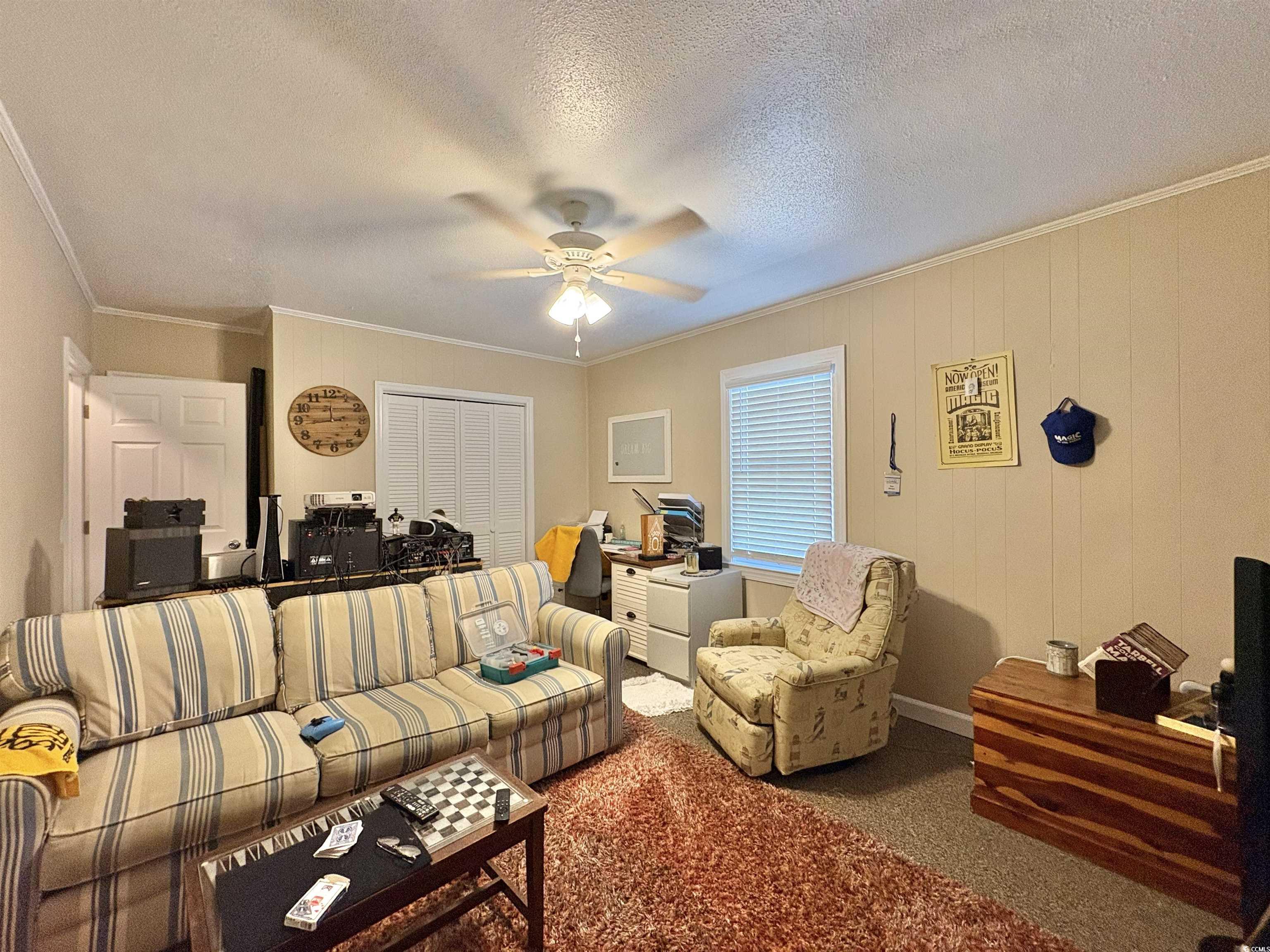 520-526 Boundary Avenue Murrells Inlet, SC 29576 - Photo 10 of 38 Living area with ornamental molding, carpet floors, a textured ceiling, and ceiling fan
