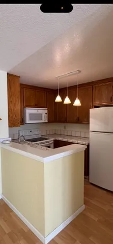a kitchen with stainless steel appliances a sink and a refrigerator