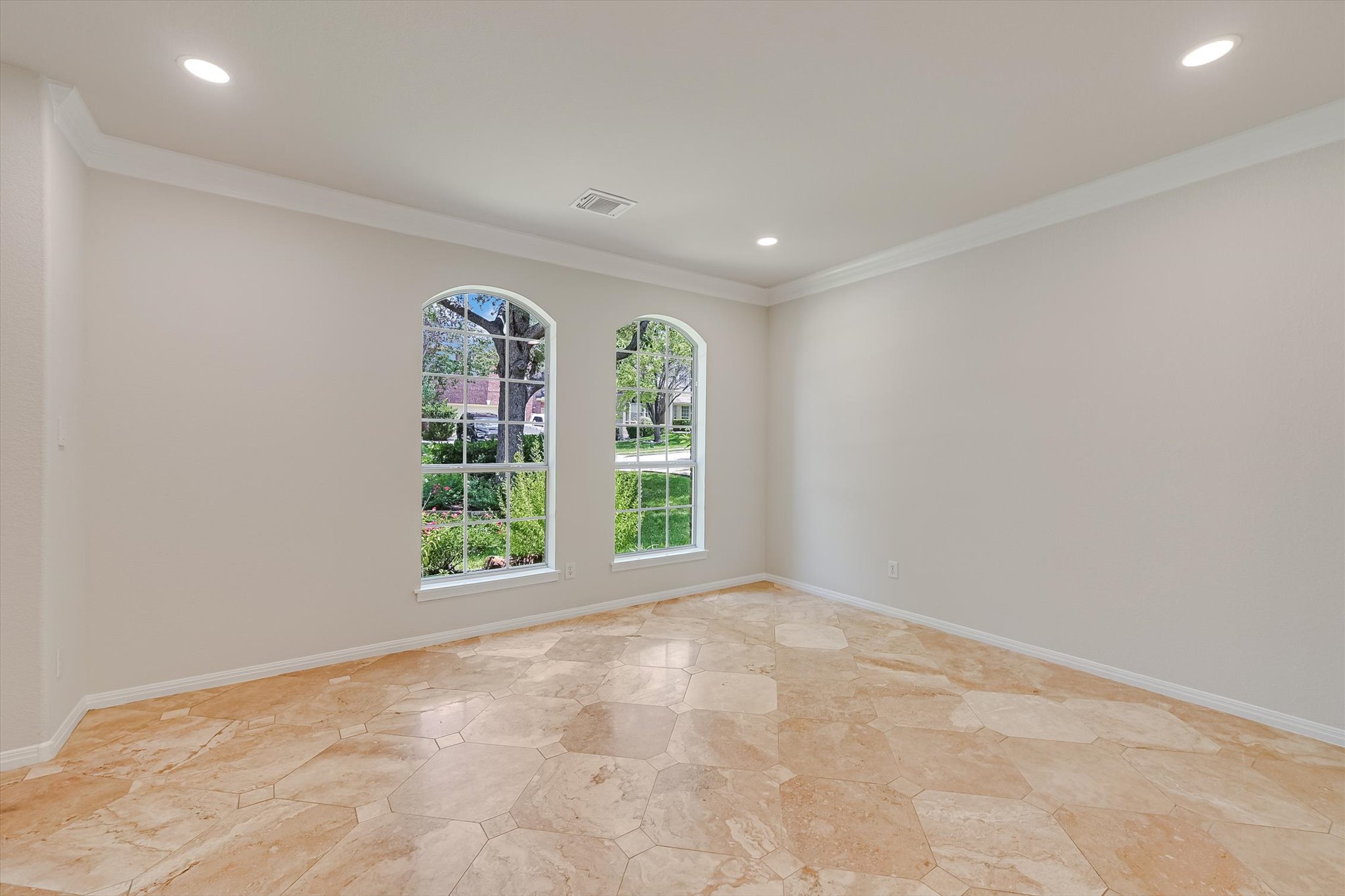 2849 Grimes Ranch Road Austin, TX 78732 - Photo 3 of 31 Two elegant arched windows illuminate this versatile room with warm natural light.