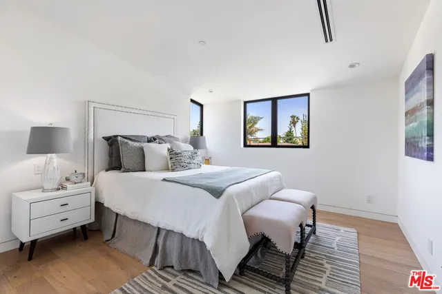 a bedroom with a bed and a couch