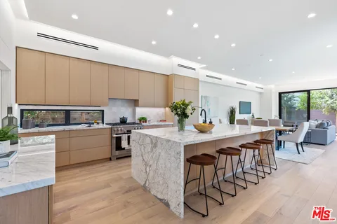 a kitchen with appliances a sink a counter top space and cabinets