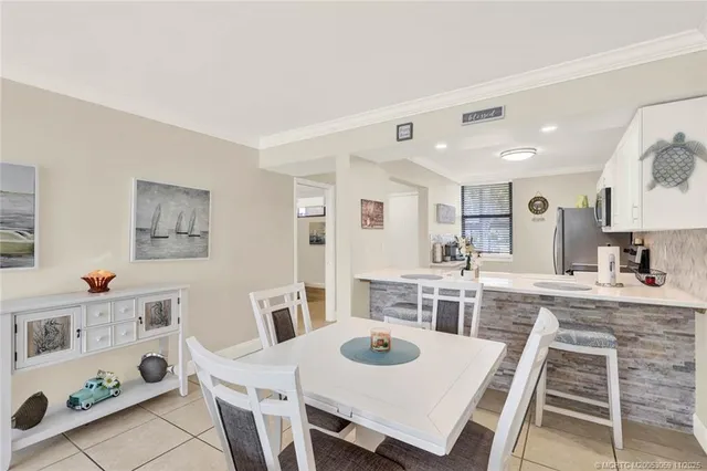 a view of a dining room with furniture a chandelier and wooden floor