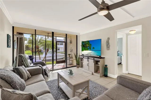 a living room with furniture and a floor to ceiling window