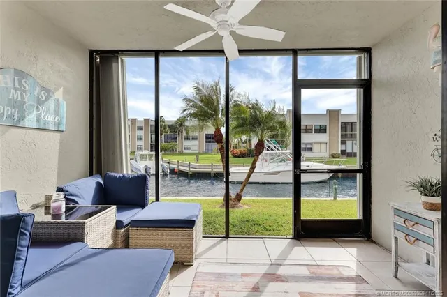 a living room with furniture and a floor to ceiling window