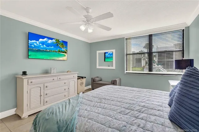 a view of a bedroom with furniture and flat screen tv