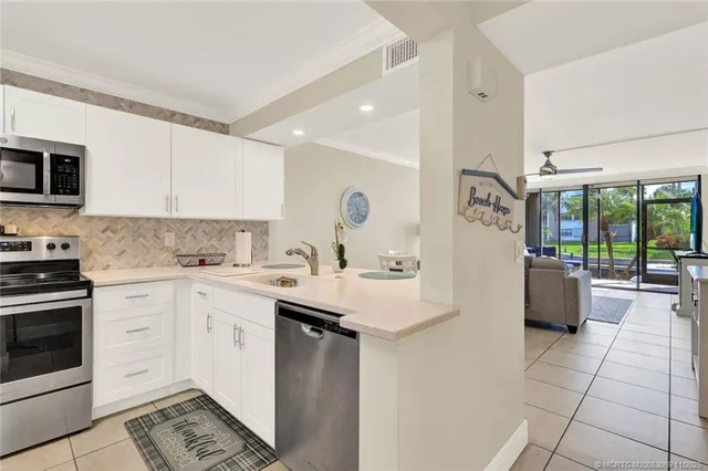 a kitchen with a sink and a stove top oven