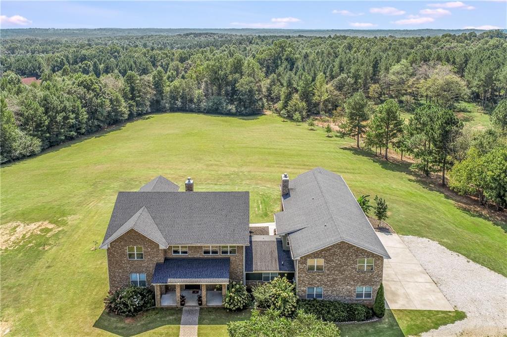 820 Sims Bridge Road Commerce, GA 30530 - Photo 1 of 1 an aerial view of a house with a garden and lake view